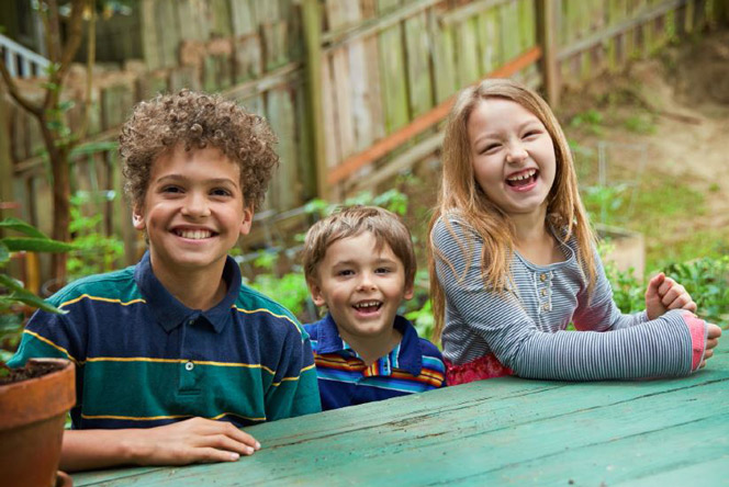 Kim's grandkids sitting at the backyard picnic table. Kim's grandkids sitting at the backyard picnic table.